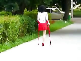 amputee girl wearing a single red heel